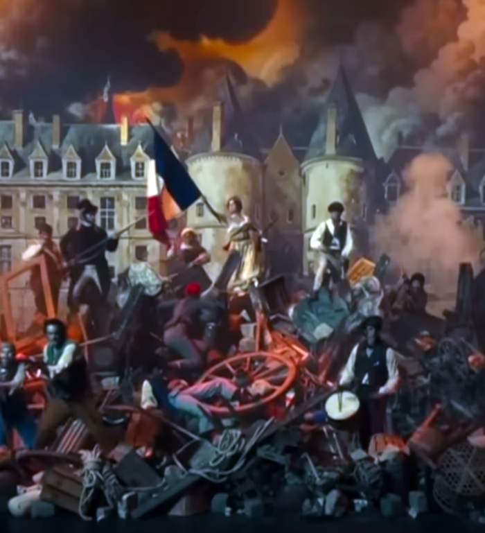 woman with French flag on top of a barricade