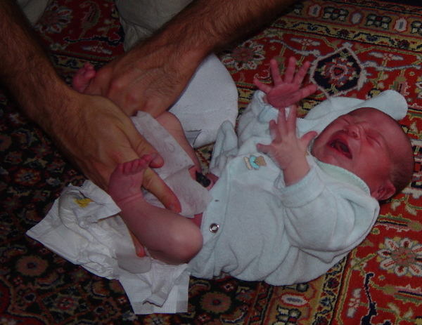 father changing infant's diaper